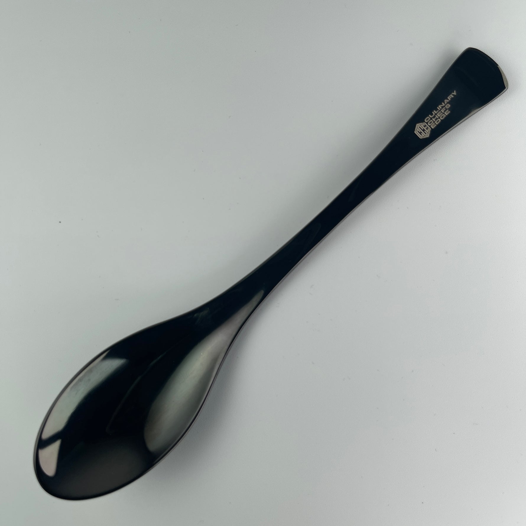 Titanium quenelle spoon designed for precise plating and elegant presentation